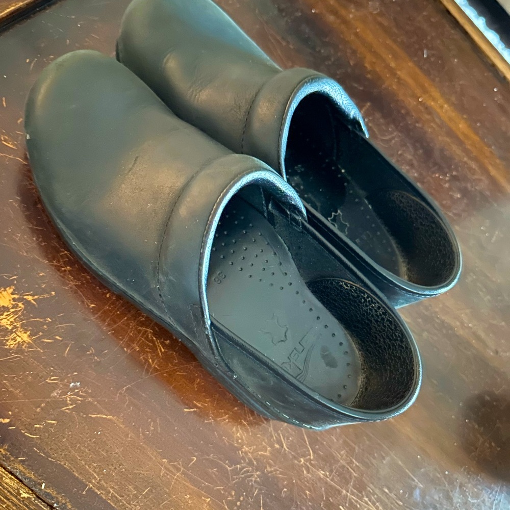 Black Dansko clogs.